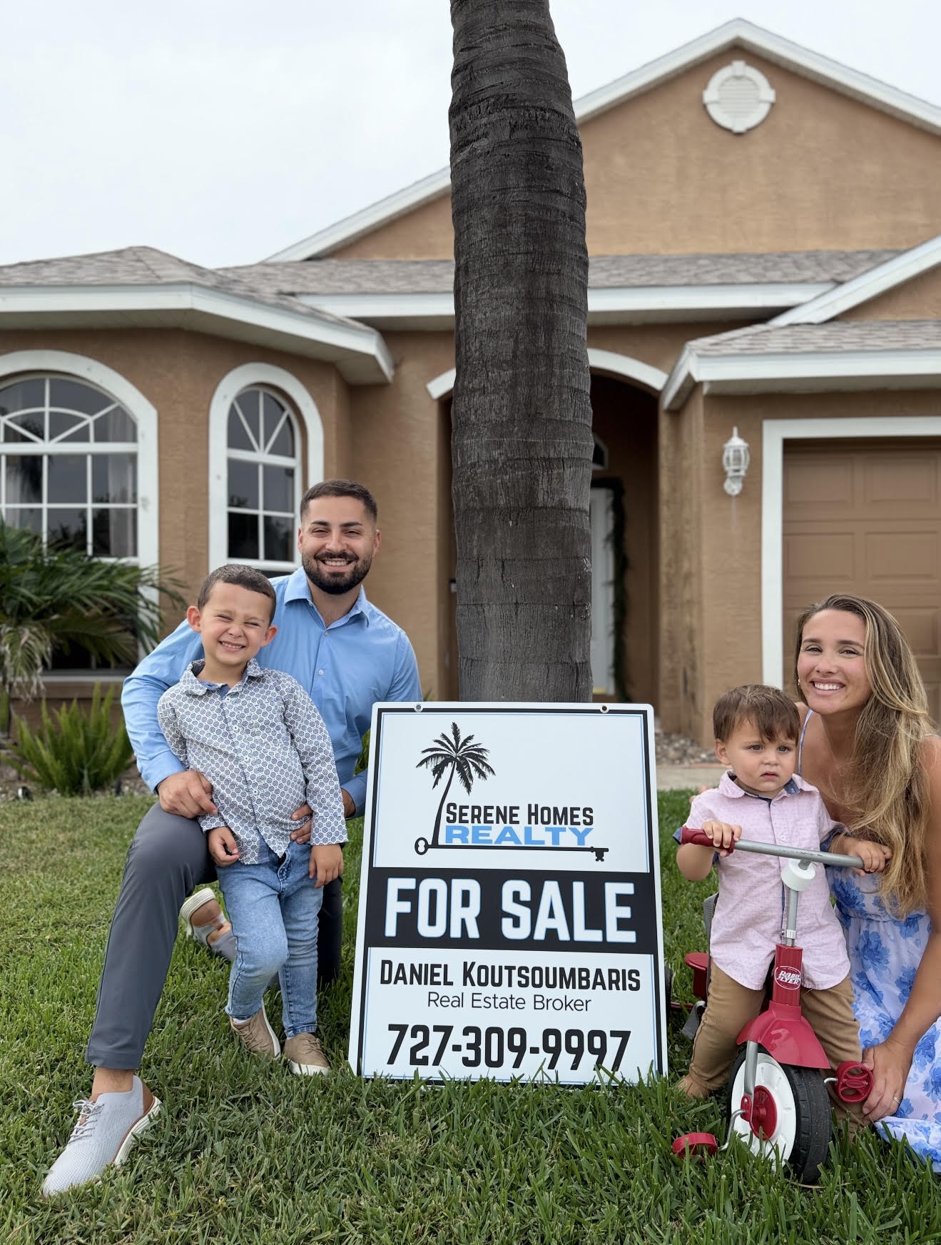 The Koutsoumbaris family in front of a home they sold